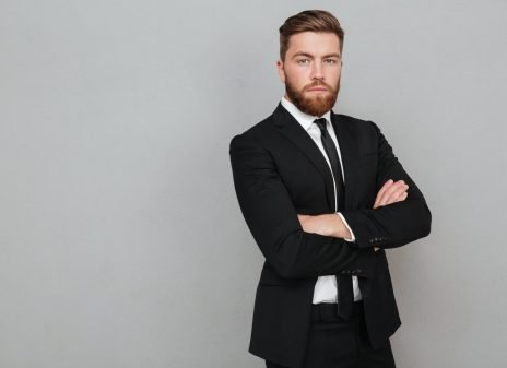 confident-young-businessman-suit-standing-with-arms-folded-scaled.jpg